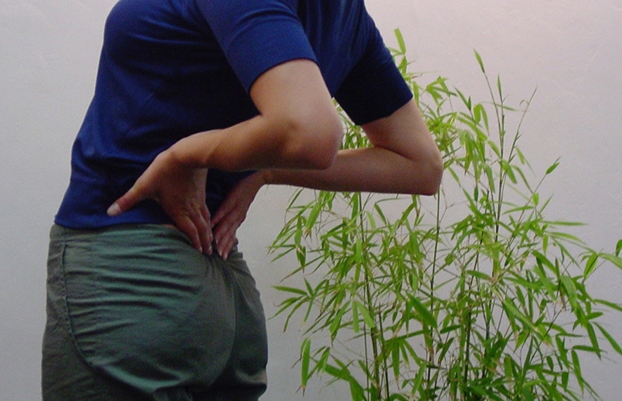 Woman giving self-acupressure treatment.