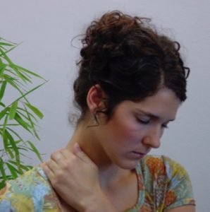 Woman giving self-acupressure treatment.