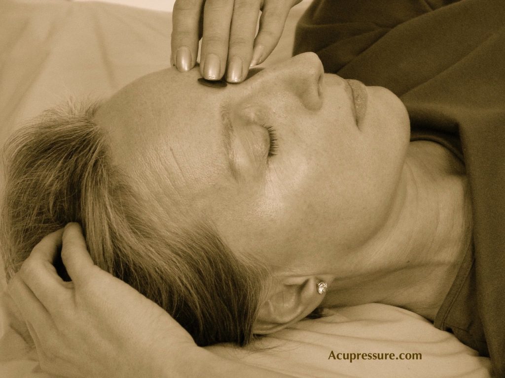 Acupressure point on a women forehead