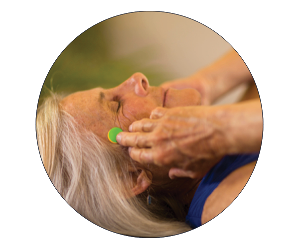 Woman holding facial acupressure points.