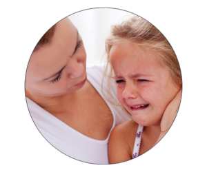Woman holding crying little girl.
