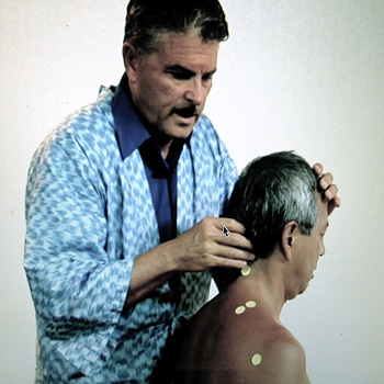 Michael Reed Gach giving acupressure treatment.