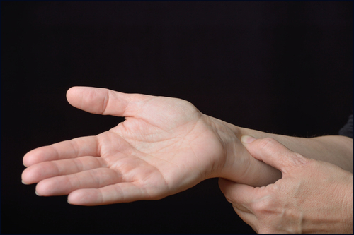 Person holding acupressure point P 6.