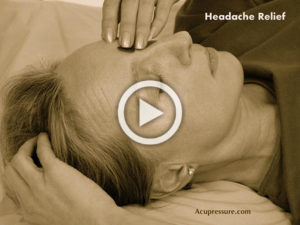Woman holding facial acupressure points.