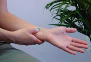 Woman demonstrating acupressure point P 6.