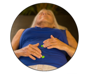 Woman holding acupressure points on stomach.
